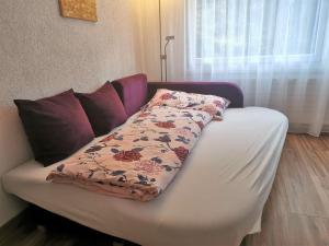 a white couch with a blanket on top of it at Modern renoviert mit Hallenbad + Fitness in Laax +37 photos
