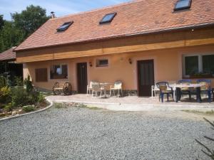 a house with a table and chairs in front of it at Chalupa, 3x apartmány, 11 lůžek. in Sedlec