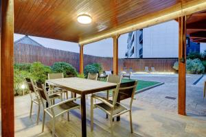 a wooden table and chairs on a patio at Villa Oasis by SanSe Holidays in San Sebastián
