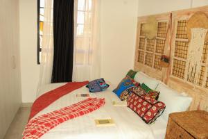 a white bed with pillows on it in a room at Wakanda@HeArt Stays in Kakamega