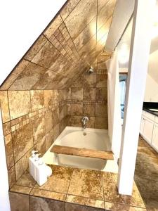 a bathroom with a bath tub in a room at Downtown Sunny Penthouse ! in Denver