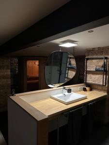 a bathroom with a sink and a large mirror at Loft mit privater Sauna in Heidelberg