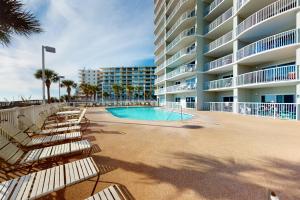 a swimming pool in front of a large apartment building at Tradewinds 601 in Orange Beach