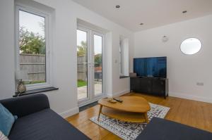 a living room with a couch and a table at Hideaway Cottage in Bristol