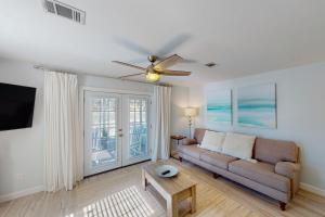 a living room with a couch and a ceiling fan at Summer Lake Townhomes 1 in Destin