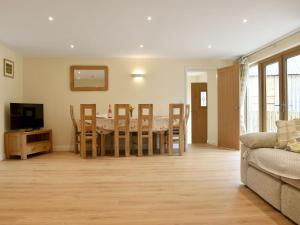 a living room with a table and a couch at South Barn in Monk Okehampton