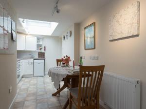 a kitchen and dining room with a table and chairs at Little Trout in Middle Wallop