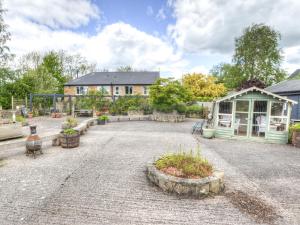 a courtyard with a house and a building at Hadrians Garden Villa in Bardon Mill