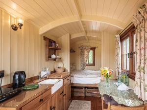 a kitchen with a sink and a bed in a room at The Nuthatch - Uk40297 in Martin