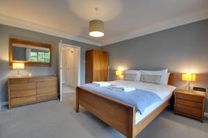 a bedroom with a large bed and two night stands at Mauve in Poole