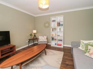 a living room with a couch and a coffee table at Castle View Annex in Wareham