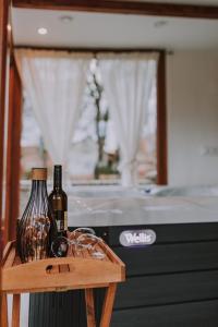 two bottles of wine sitting on a wooden table at Holiday home The view in Sveti Urban +16 photos