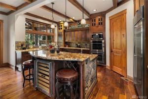 a kitchen with a large island with a stone counter top at The 17th hole in Cle Elum