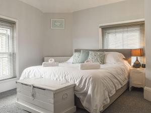 a bedroom with a large bed with white sheets at Shooters Cross Apartment in Cowes