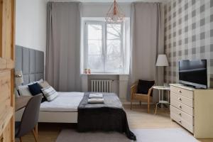 Televízia a/alebo spoločenská miestnosť v ubytovaní Warsaw Concierge Wilanowska