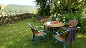 a table and chairs sitting in a yard with a view at Allt Beag in Lochearnhead
