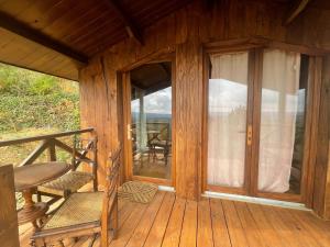 porche de una cabaña de madera con puerta de cristal en 7eme ciel - Tiny House avec Grande Piscine intérieure chauffée toute l'année, en Marais-Vernier