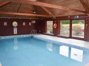a large swimming pool in a house with a ceiling at Keel Cottage in Whitby