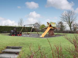 a playground with a slide in a park at Keel Cottage in Whitby