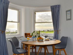 a dining room with a table and chairs and a window at Guillemots in Littlehampton