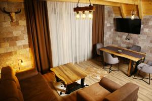 a living room with a couch and a table at WOLFOREST in Žabljak