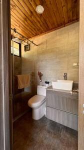 a bathroom with a toilet and a sink at Vaikuntha House 