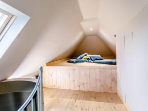 a bed in the attic of a house at The Telephone Exchange in Codford Saint Mary