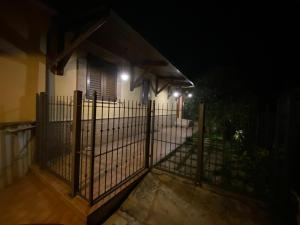 a fence in front of a house at night at BELLA ASSISI B & B in Assisi