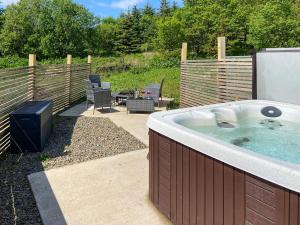 a jacuzzi tub in a yard with a patio at Uk7384 - The Hayloft in Newmilns