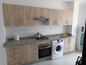 a kitchen with a washing machine and a washer at place to be saidia in Saïdia