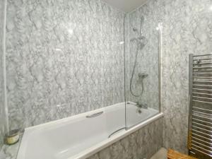 a bathroom with a shower with a bath tub at Largs Brisbane Cottage in Largs