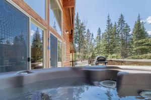 a hot tub on the side of a house at Raven Haven Lodge by NW Comfy Cabins in Leavenworth