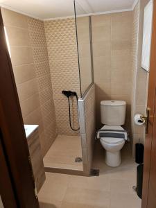 a small bathroom with a toilet and a shower at Serres Kavafi 7 city center , FREE PARKING , FREE NETFLIX in Serres