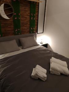 a bed with two towels sitting on top of it at Serres Kavafi 7 city center , FREE PARKING , FREE NETFLIX in Serres