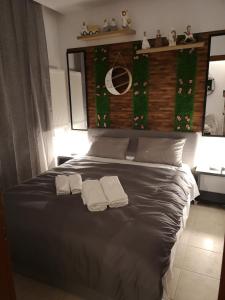 a bedroom with a bed with two towels on it at Serres Kavafi 7 city center , FREE PARKING , FREE NETFLIX in Serres