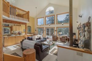 a large living room with a large stone wall at Pine Tree Cottage by NW Comfy Cabins in Leavenworth