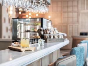 a bar with a drink sitting on a counter at ibis Bangkok Sukhumvit 24 in Bangkok