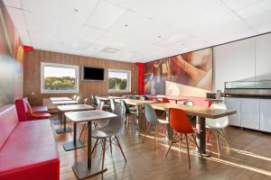 a restaurant with tables and chairs in a room at Sure Hotel by Best Western Spånga in Stockholm