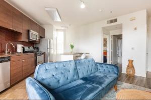a living room with a blue couch in a kitchen at Tulum Vibes 1 Bedroom Apartment near Boats in Marina Del Rey in Los Angeles