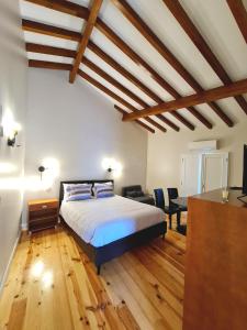 ein Schlafzimmer mit einem Bett und ein Wohnzimmer in der Unterkunft Quinta da Abadia in Mangualde