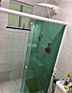 y baño con ducha y puerta de cristal. en ALUGO CASA INTEIRA EXCELENTE Casa de temporada em Cabo Frio, en Cabo Frío