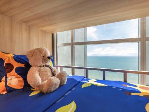 Mövenpick Siam Hotel Na Jomtien Pattaya客房内的一张或多张床位