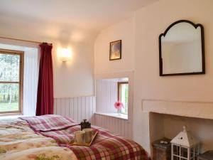 a bedroom with a bed and a mirror on the wall at St Orans in Rafford