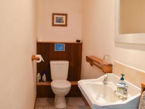 a bathroom with a toilet and a sink at St Orans in Rafford