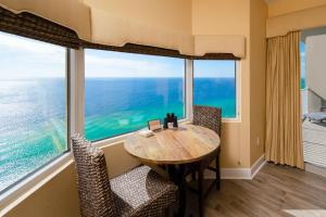 uma sala de jantar com mesa e cadeiras e uma grande janela em Tidewater2808 em Panama City Beach
