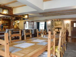 a dining room with a large wooden table and chairs at Lamb Inn in Stoke Prior