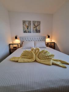 新瓦羅許的住宿－Zlatar Holidays Apartmani，床上放着一双动物毛巾