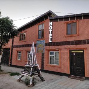 a building with a christmas decoration in front of it at Family Guest house - Friends-J in Nukus