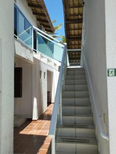 a stairway in a building with a blue railing at Pousada Sol da Manhã in Guarujá