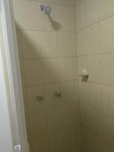 a bathroom with a shower with a glass door at Posada villa aurora in Bernal